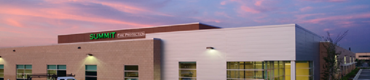 A Summit Companies office building against a sunset background