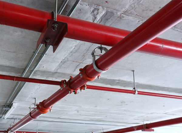 Red industrial pipes lined throughout the ceiling