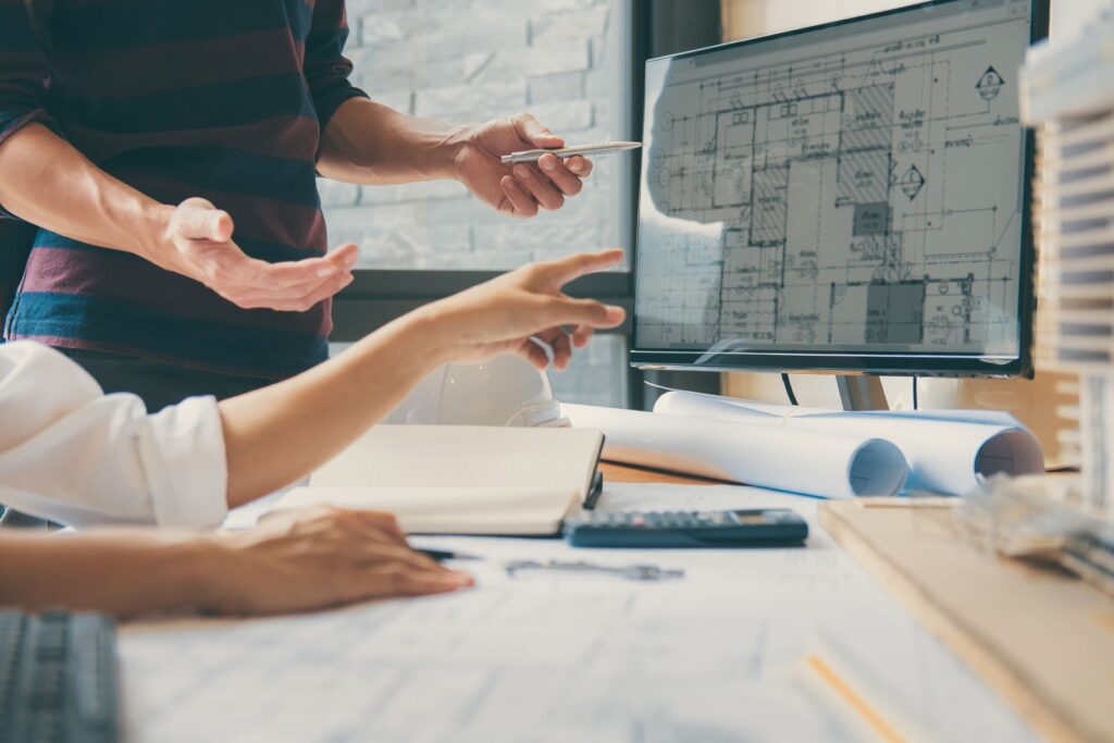 Discussing architectural plans on computer