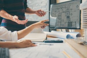 Discussing architectural plans on computer