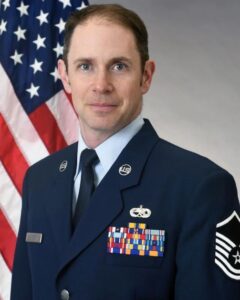 Military personnel in uniform with medals.