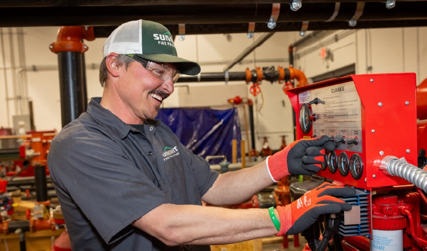 Employee operating machinery in workshop.
