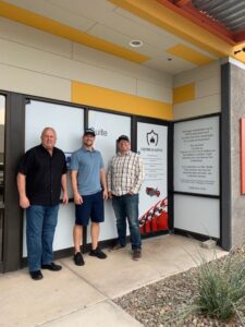 team members standing outside of the office building