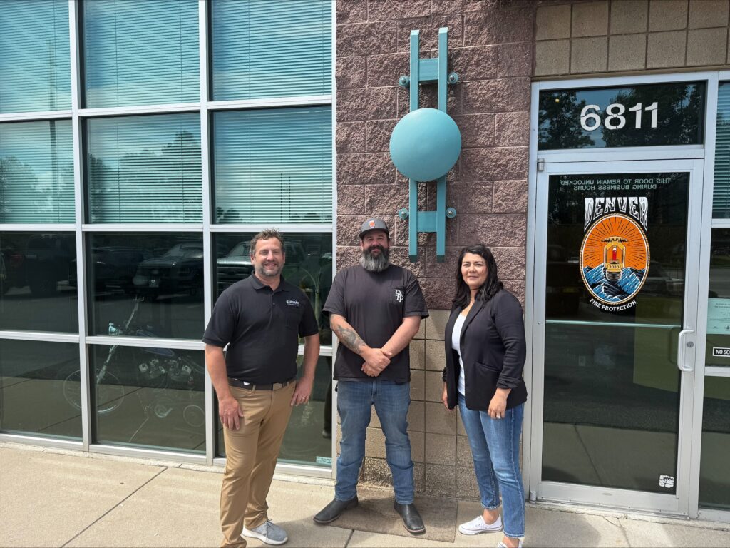 team standing outside the Denver Fire Protection office