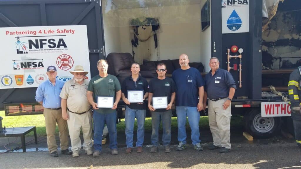 Group receiving awards outdoors