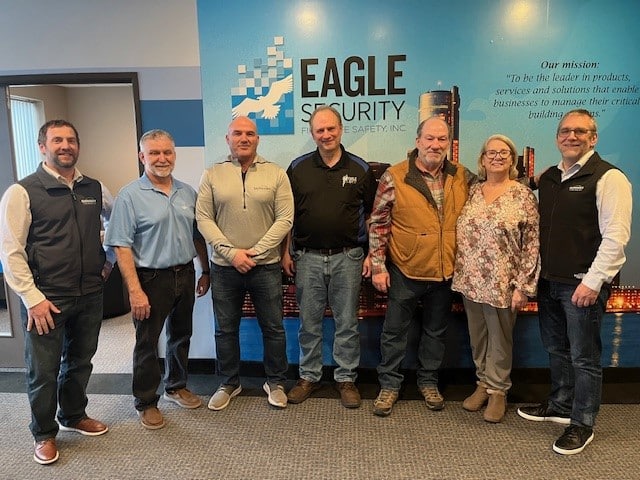 the team standing inside the office building