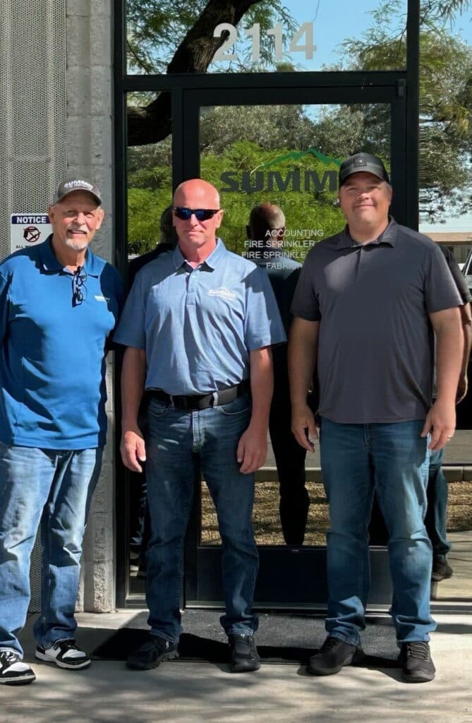 the team standing outside of the office building