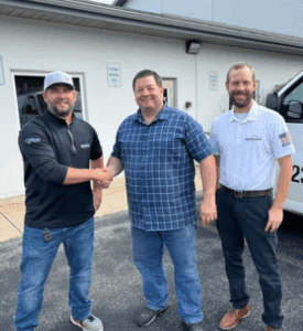 the team standing outside of the office building