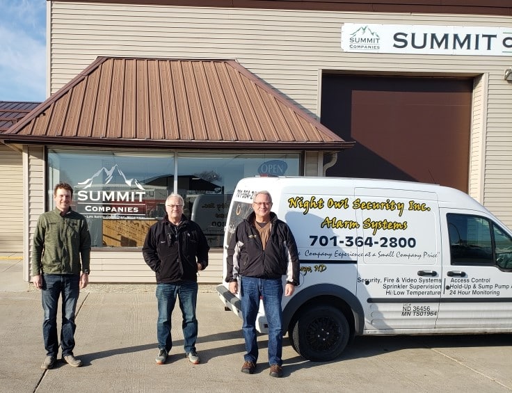 team members standing outside of the office building