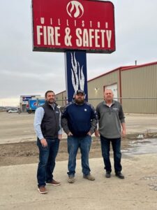 the team standing outside of the office building