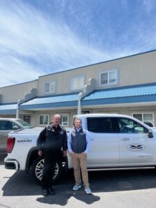 Two people standing outside of the office building