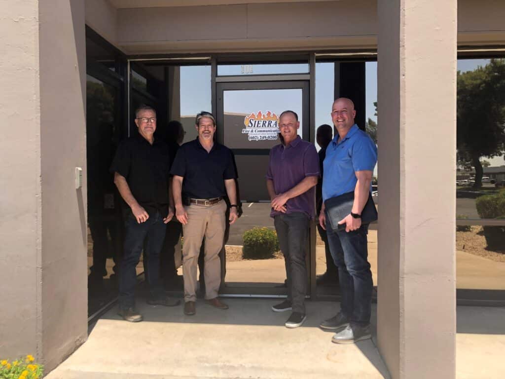 team members standing outside of the office building