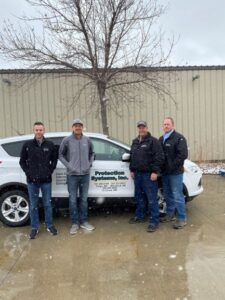 team members standing outside of the office building