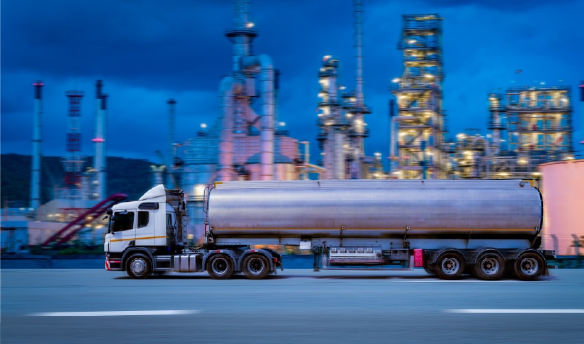 Truck near industrial oil refinery at dusk