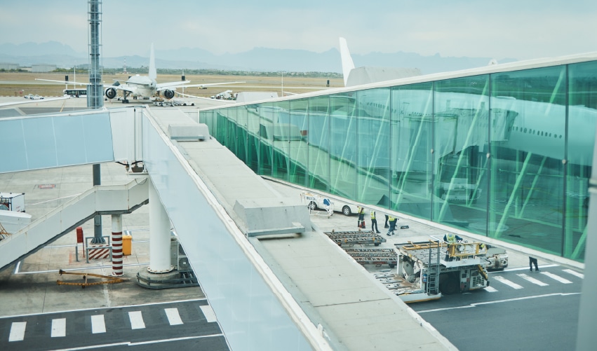 Airport terminal with planes outside.