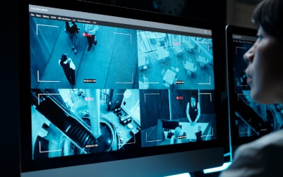 Surveillance footage on computer screens.