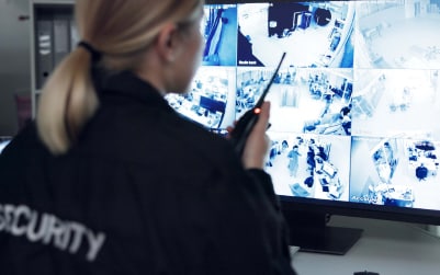 Security personnel monitoring surveillance screens.