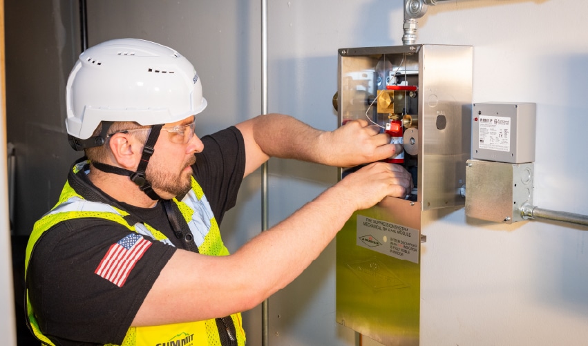 Person working on fire protection equipment.