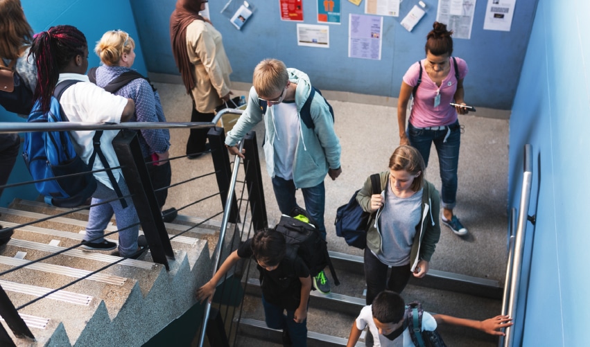 Students walking down a staircase.