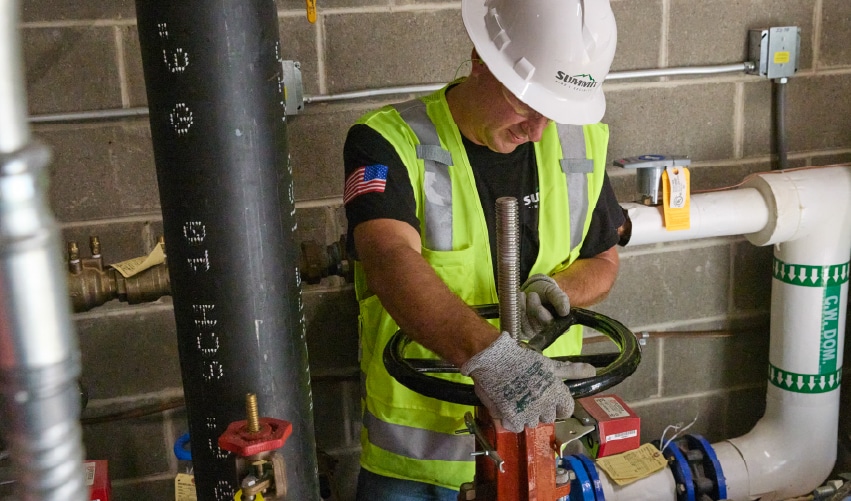 Worker adjusting fire protection equipment