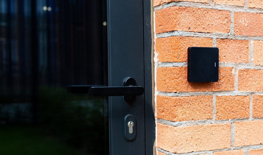 Black security device on brick wall