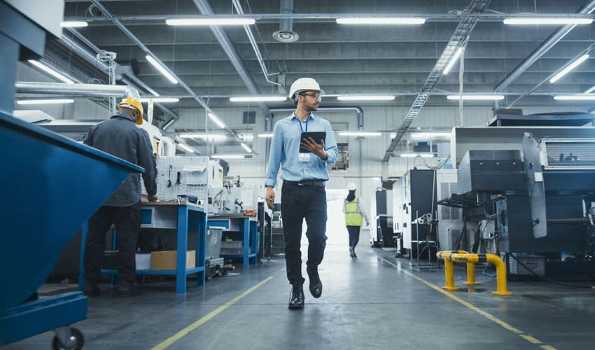Worker walking in manufacturing facility