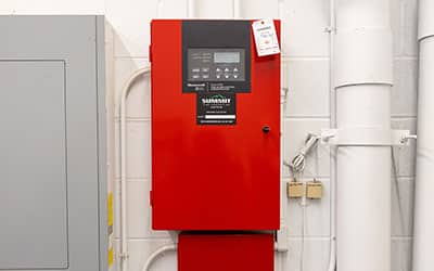 Red fire alarm control panel mounted