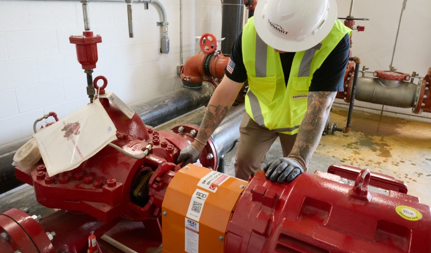 Worker inspecting fire protection equipment