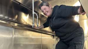 Brandi working on fire suppression in a restaurant