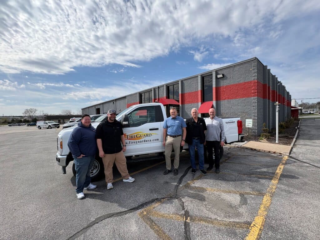 Recent acquisition of FireGuard employee and Fire Protection Employees next to Summit Fire Protection Truck