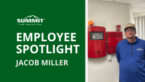 Fire Technician standing next to fire alarm panels